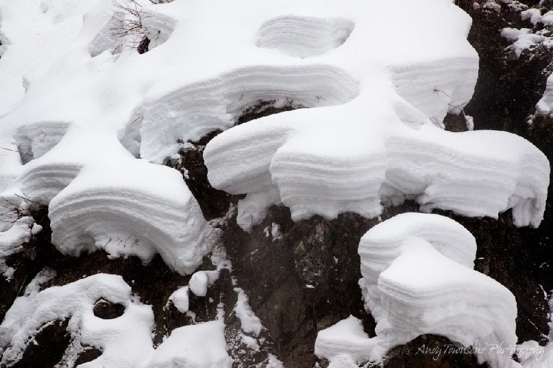 Steam from the boiling water of the Yokoyu-River shapes and sculpts the snow above it.