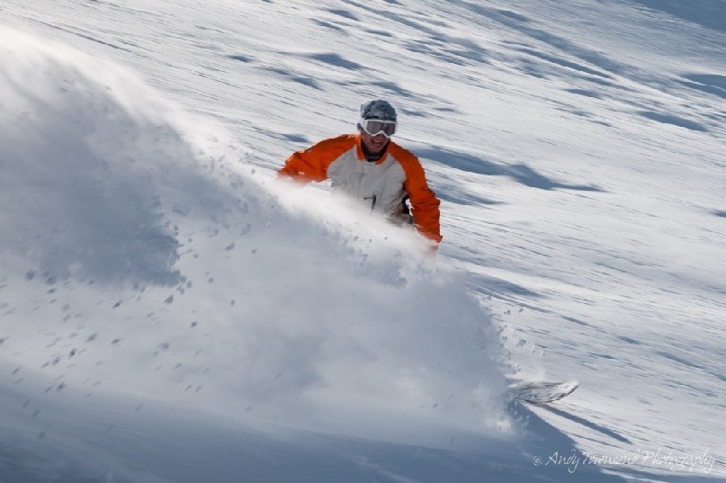 A snowboarder smiles as a plume of fresh snow sprays out.<br />
<br />
Mount Olympus Ski Area, dubbed "playground of the gods", is a club skifield in Craigieburn Range, on New Zealand's South Island.