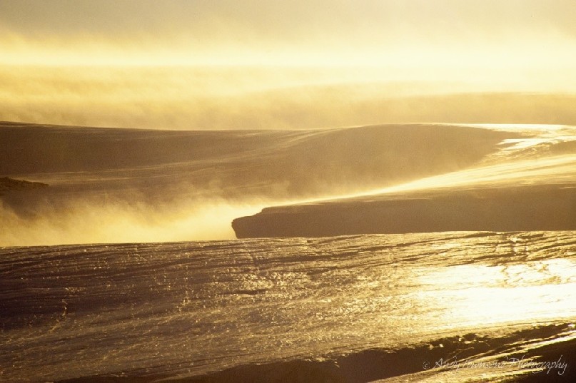 The most powerful winds on our planet are caused by cold air from the high Antarctic plateau picking up speed as it slides down the icy slopes to the coast. These gravity-driven ‘katabatic winds’ have been recorded at speeds up to 320 kilometres an hour. Passing over the ice, they polish its surface into a glassy finish.