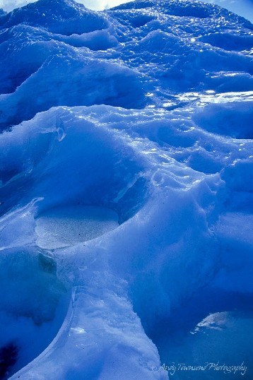 Small melt pools the size of dinner plates sculpts the side of this glacial wall.