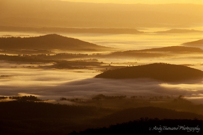 In the early morning, valley mist accumulates and then slowly dissapates as the golden sunlight warms the air.