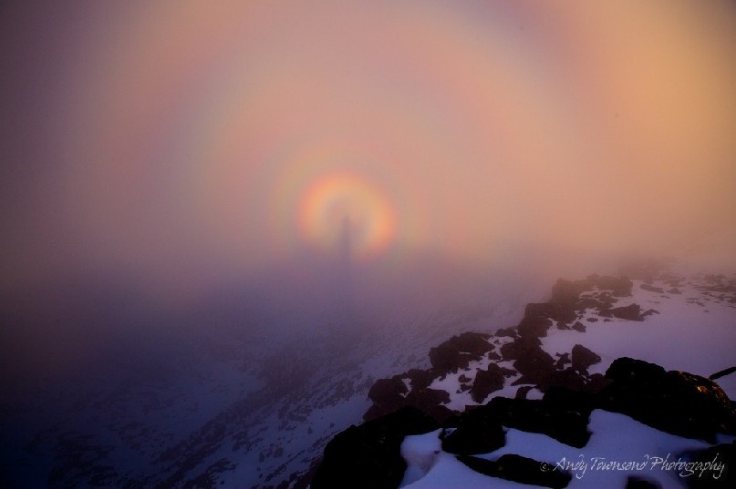 This brocken spectre or mountain spectre is a long magnified shadow cast onto cloud forming over the snow covered Rodway Range. The shadow is surrounded by rainbow-coloured fringes caused by defraction of light.