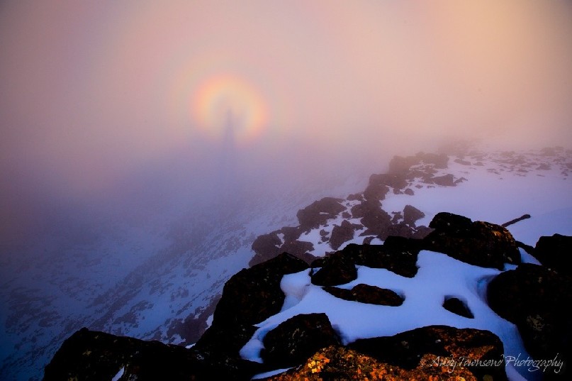 This brocken spectre or mountain spectre is a long magnified shadow cast onto cloud forming over the snow-covered Rodway Range. The shadow is surrounded by rainbow coloured fringes caused by the defraction of light.