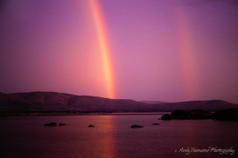 Twin rainbows form across the bay at Palana Beach, Flinders Island.