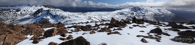 A panoramic view showing the range from Florentine Peak to Mt Field West and the distant vista of the South west wilderness.