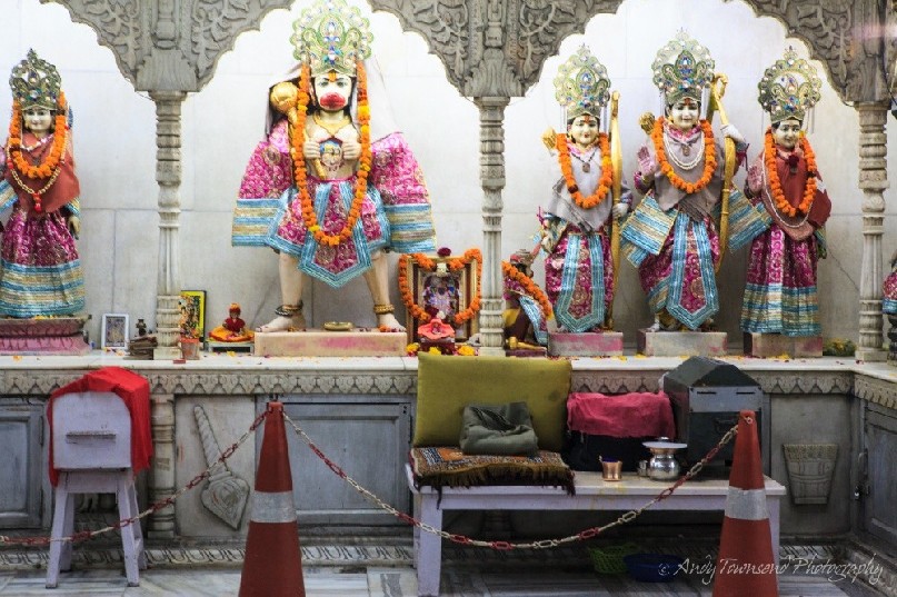 India gods are highlighted in a small city shrine.