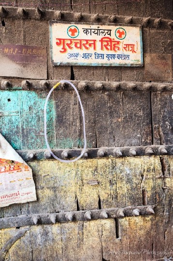 A spiked wooden door splashed with turqouise and yellow marks the entrance to the whole spice markets.