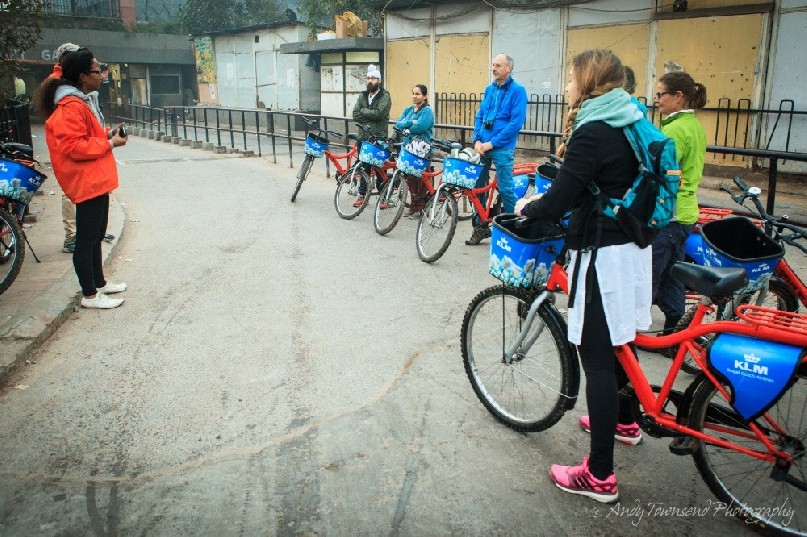 A group of bike riders gets a briefing in the early morning before tackling the Delhi streets.