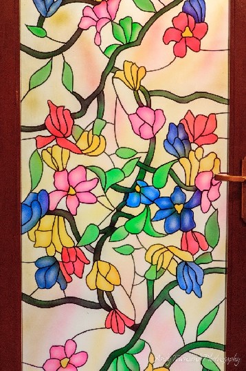 Stained glass adorns a door in an old Haveli.