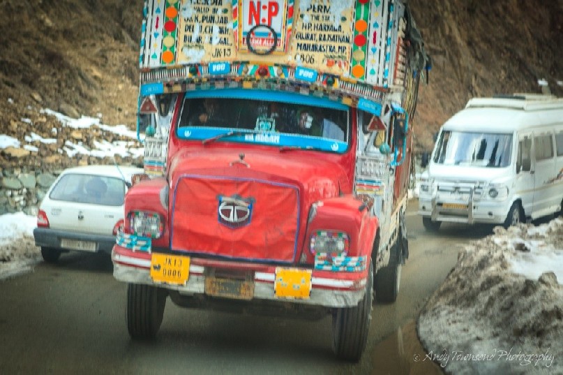 A large colourful truck makes its way towards Tangmarg village.