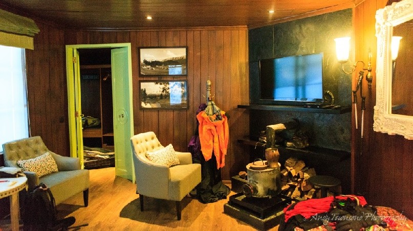 The lounge area showing fireplace and furniture in one of the hotel rooms.