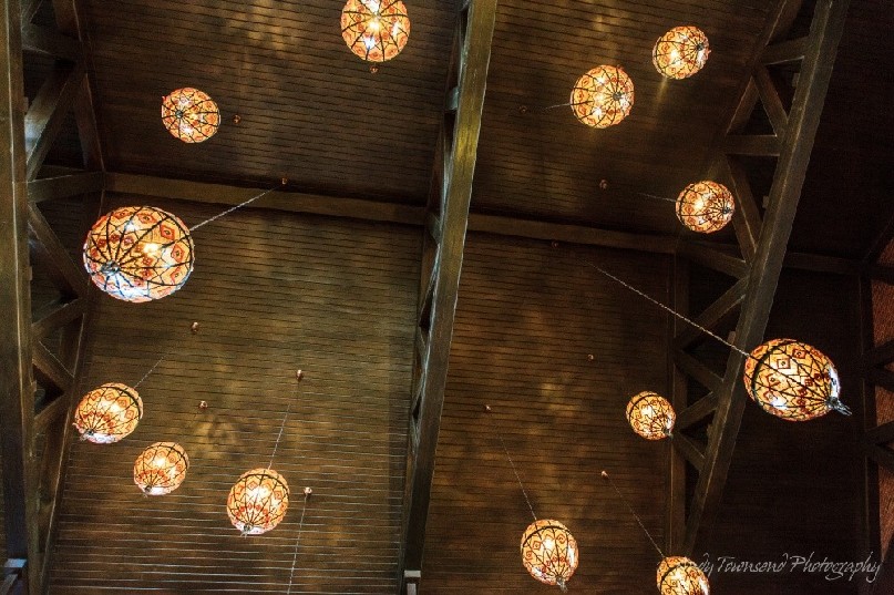 Lights hang from the wooden beams in the hotel lobby.