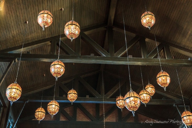 Lights hang from the wooden beams in the hotel lobby.