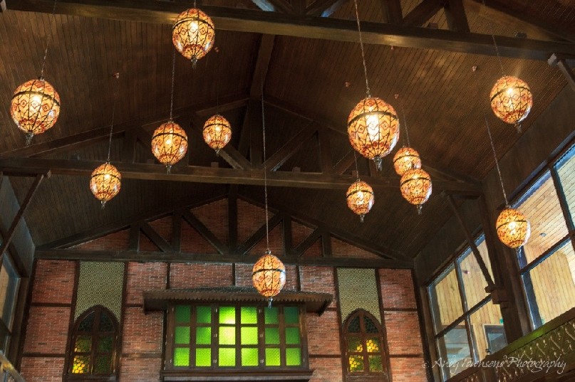 Lights hang from the wooden beams in the hotel lobby.