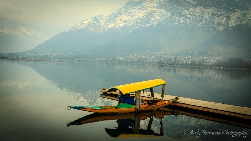 View over a Shikara out over the still waters reflecting the Zabarwan Range.