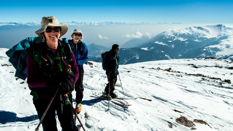 People smiling near the top of Mt Apharwat after skinning from the top of the gondola.