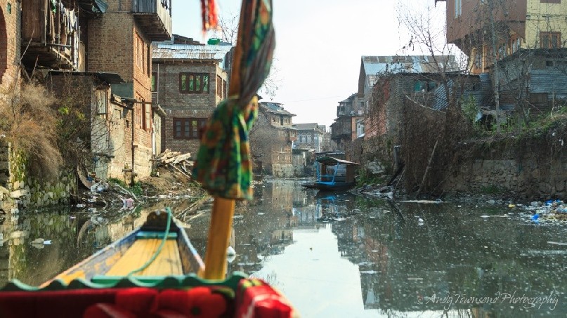 A narrow waterway off Dal Lake from a Shikara.
