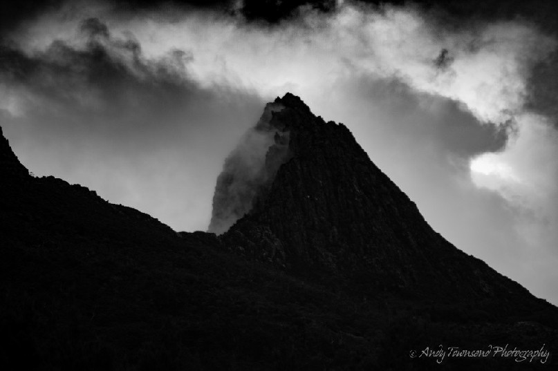 Mist builds and disapates on the east side of Cradle Mountain as storm clouds roll over.