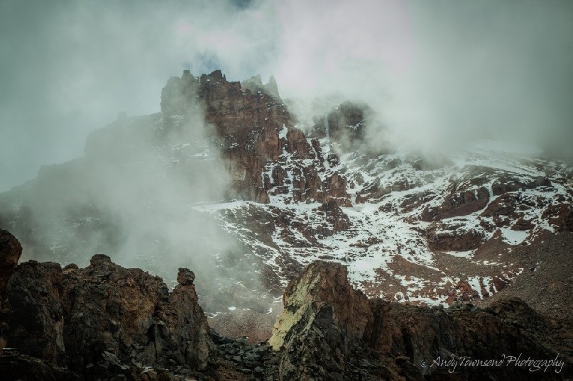 Looking up from Arrow Glacier camp towards the rim of the Kibo crater shrouded in cloud.